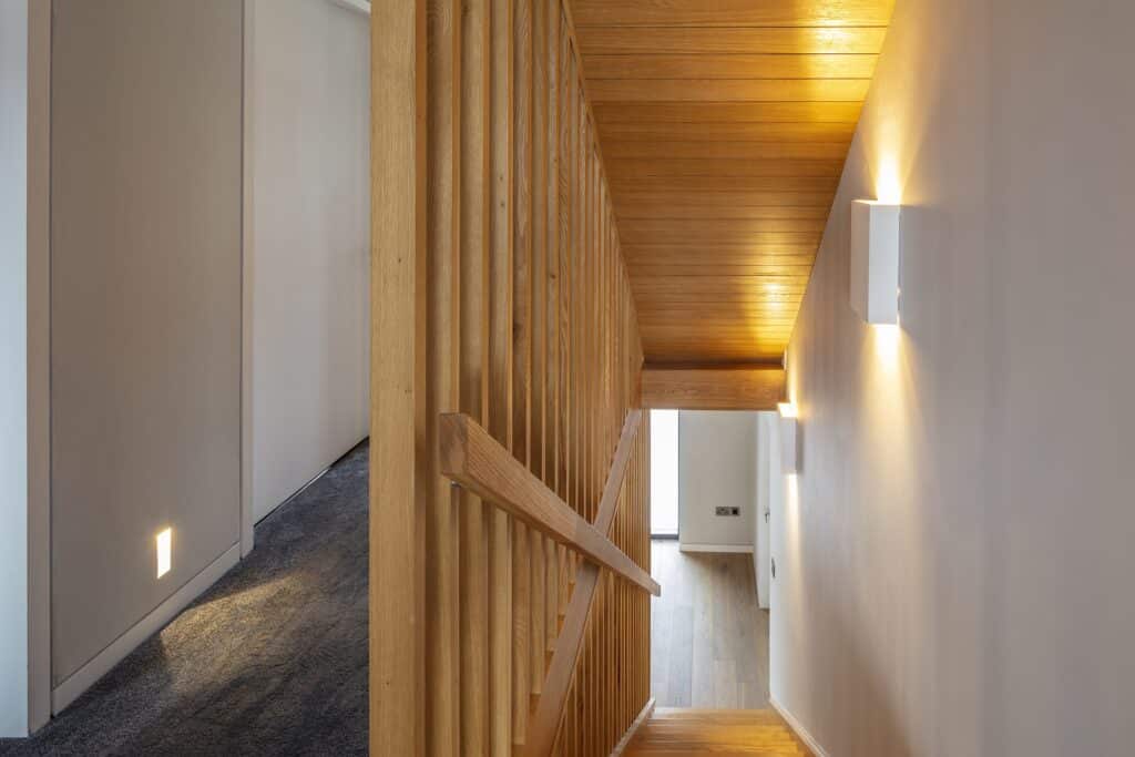 Landing and contemporary wooden staircase in a house renovation