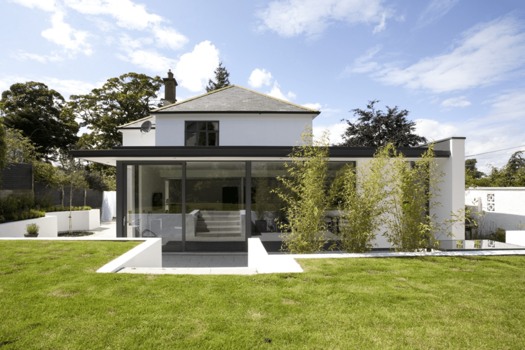 New home design in Edenderry, South Belfast, by McCann Moore Architects, featuring an exterior elevation of a modern house in slate, white render and wood