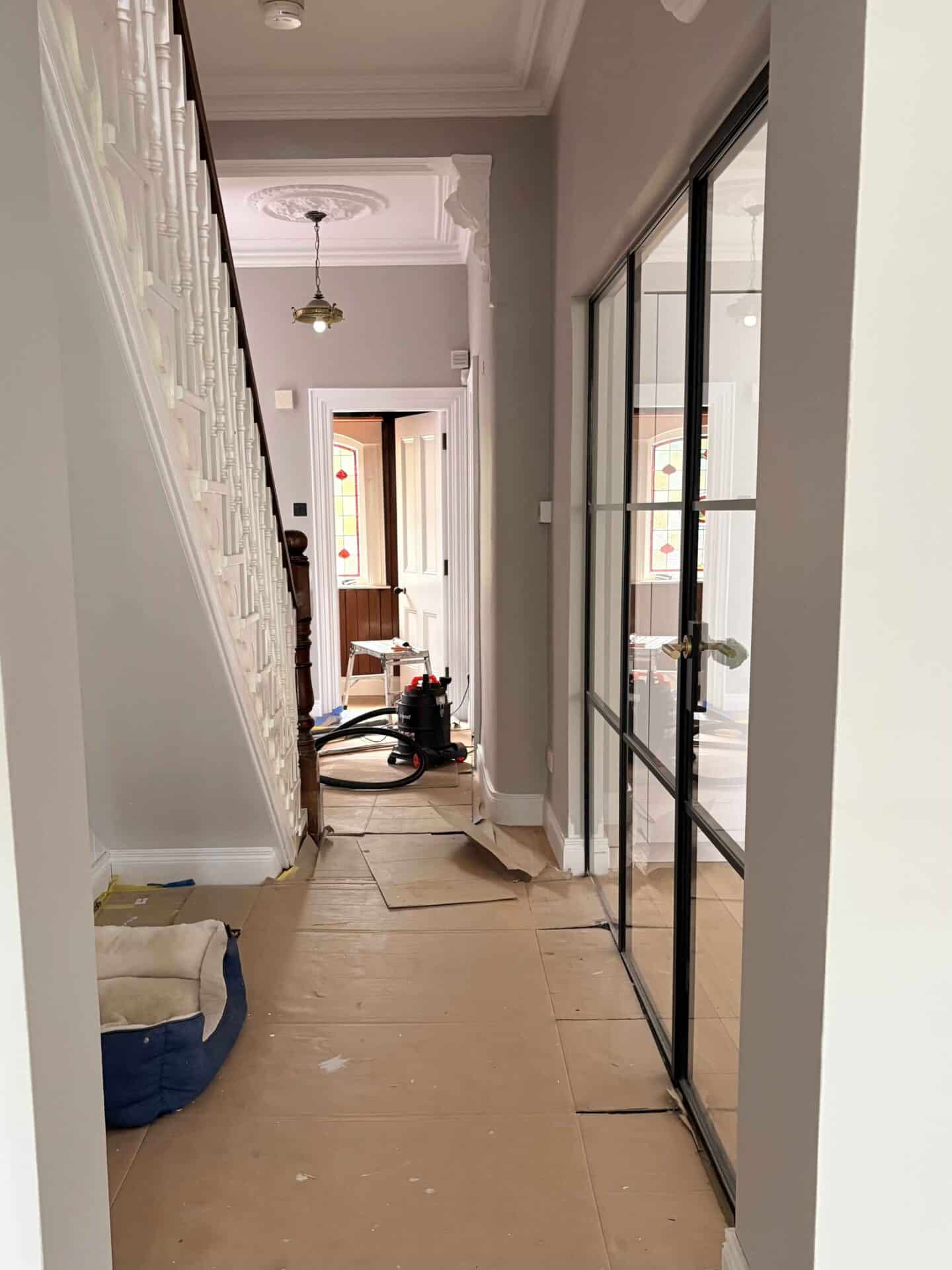 Work in progress of interior of period home extension showing hallway with steel internal glazing 