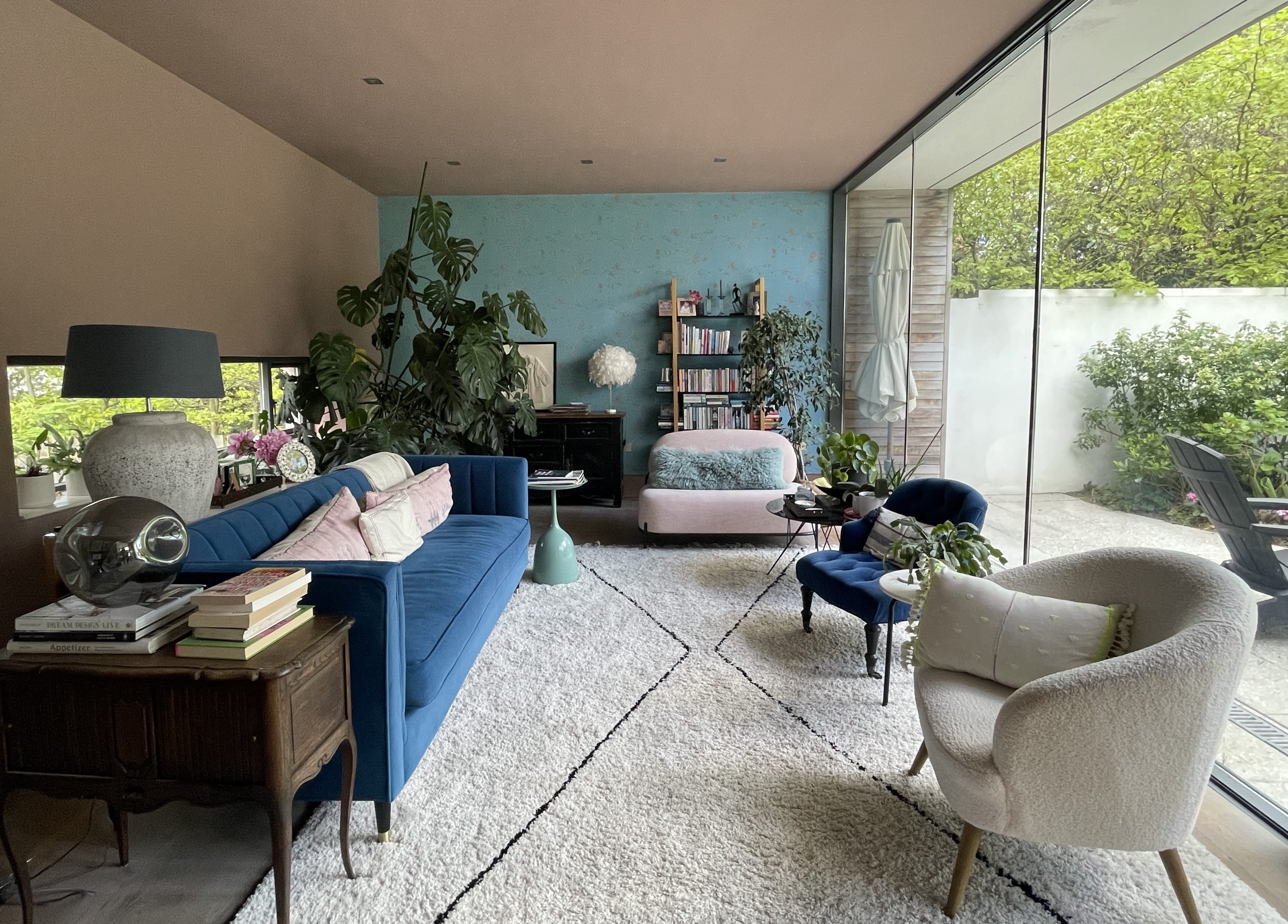 Interior of living room with fully glazed all into courtyard garden