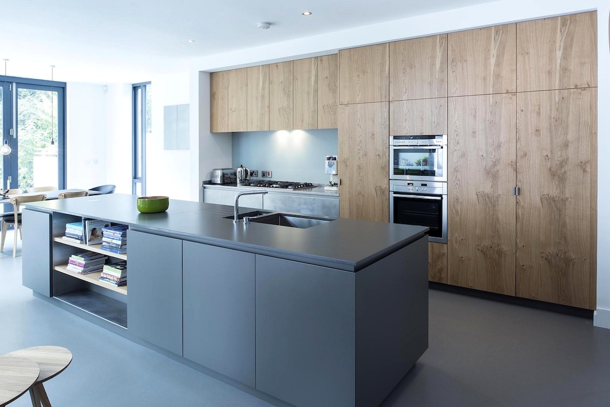 large grey island and wooden cupboards in a new kitchen/dining area in Glenageary Dublin